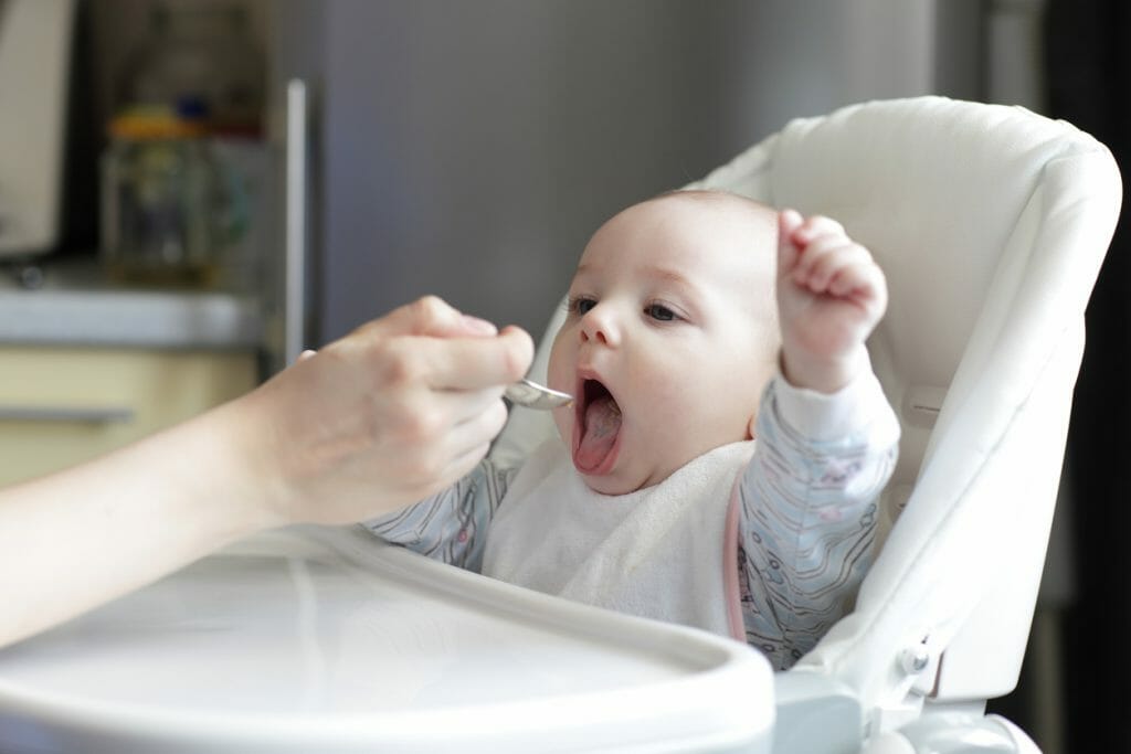 Portrait of eating baby boy at home