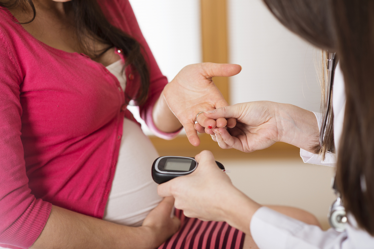 Young pregnant woman with doctor in ambulance.