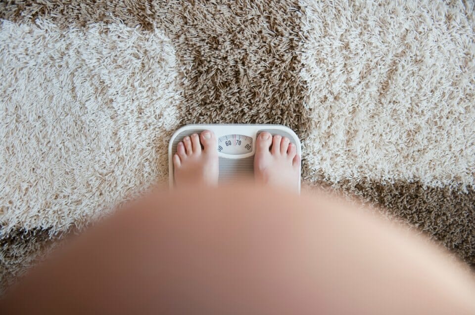 Following the 28 Day Weight Loss Challenge pregnant pregnant woman weighing herself